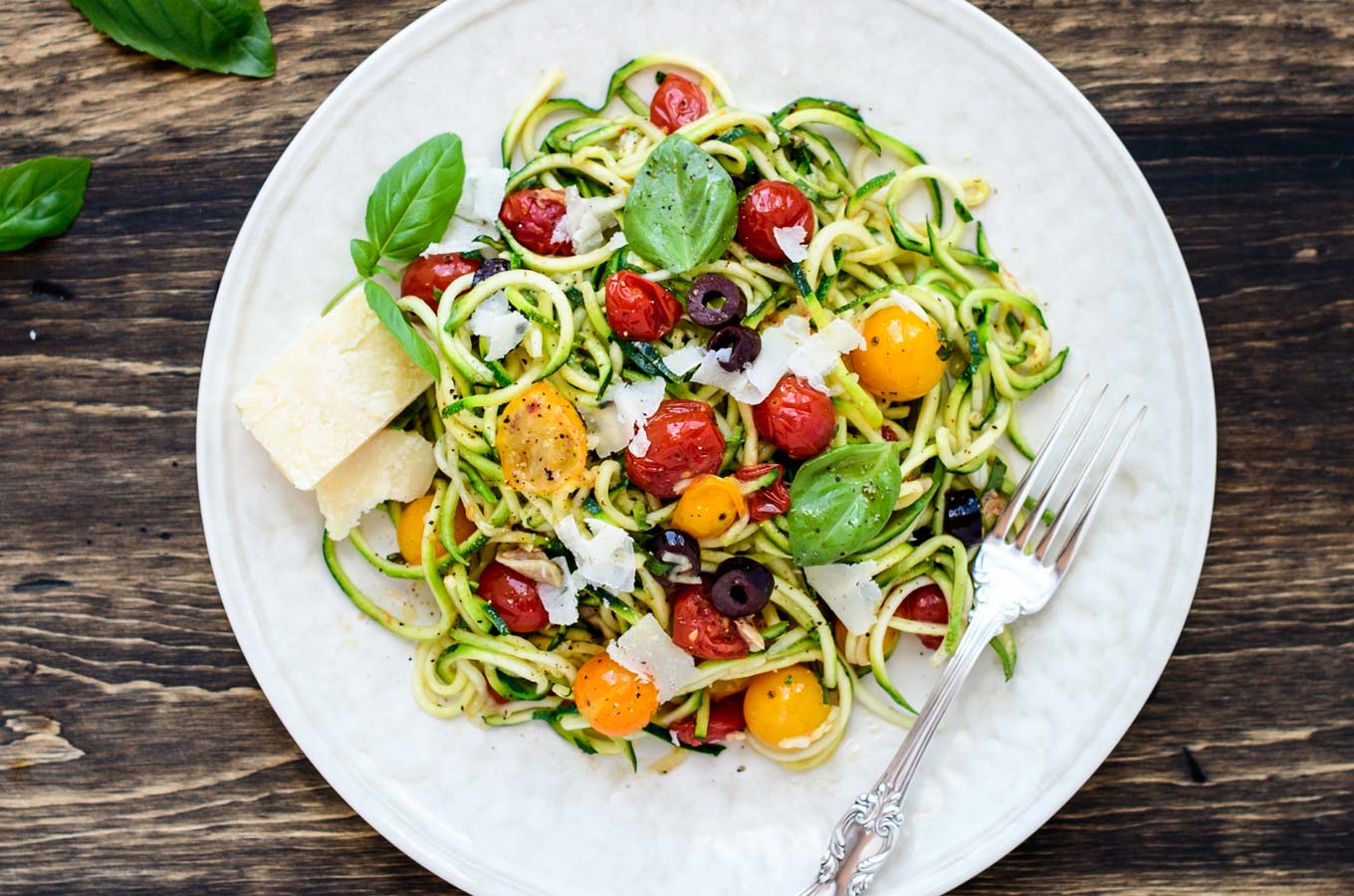 Zucchini Pasta with tomatoes and olives on a plate